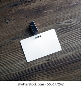 Photo Of Blank White Plastic Badge On Wood Table Background. Blank Id Card. Template For Your Design. Top View.