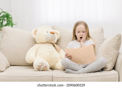 Photo Of Blond Girl Reading A Book To Her Toy Plush Friend.