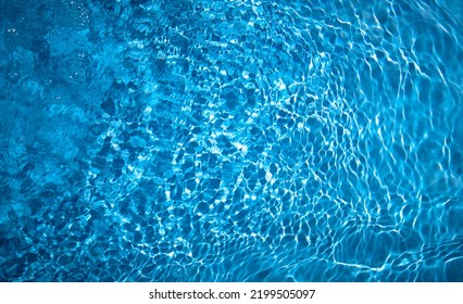 Photo Of Blue Water In The Pool. The Texture Of Clear Refreshing Water. Refresh Yourself With Water.