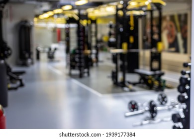 Photo Of A Blur Gym Background Fitness Center Or Health Club With Blurry Sports Exercise Equipment For Aerobic Workout And Bodybuilding. Gym Background Blurred. Blurred Gym Interior Space Background.