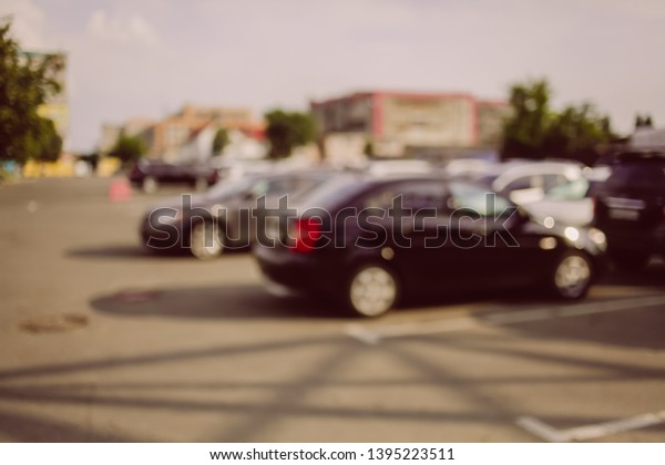 Photo of blurred\
parking cars in the city. Blur the car parked on the parking lot\
and the afternoon street. Blurred photo of Cars in the parking lot.\
vintage photo processing