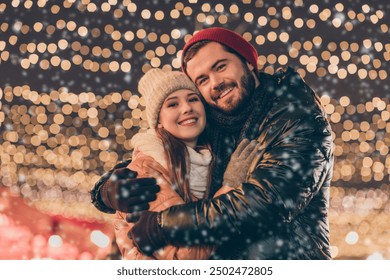 Photo of bonding boyfriend hug his affectionate girlfriend under x-mas christmas lights evening outdoors wear season coats scarf - Powered by Shutterstock