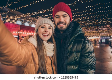 Photo of bonding loving couple make selfie on x-mas christmas illumination town event wear season coats - Powered by Shutterstock