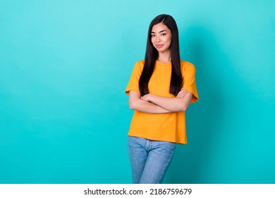 Photo Of Bossy Brunette Lady Crossed Arms Wear Orange T-shirt Jeans Isolated On Turquoise Color Background