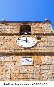 photo bottom view of the clock tower in the village of Monsanto, Portugal, Europe
