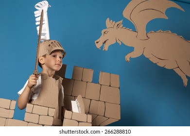 photo of the boy in medieval knight costume made of cardboards