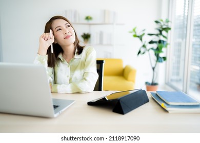 A Photo Of A Bright Asian Business Woman Working At Home In The Room. The Idea Is Work Form Home Finance Marketing Bright Portrait Simple Break The Science Bias