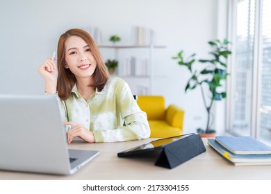 A Photo Of A Bright Asian Business Woman Working At Home In The Room. The Idea Is Work Form Home Finance Marketing Bright Portrait Simple Break The Science Bias