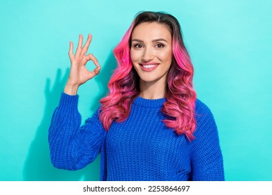 Photo of bright nice cheerful girl with curly hairdo dressed blue sweater showing okey symbol isolated on vibrant teal color background - Shutterstock ID 2253864697