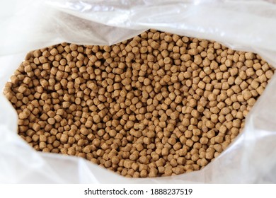 Photo Of Brown Pet Koi Fish Food Pellets