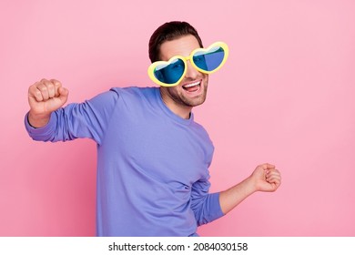 Photo of brunet cool guy dance wear spectacles blue sweater isolated on pink color background