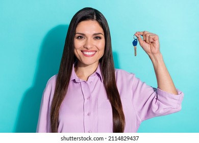 Photo Of Brunette Optimistic Young Lady Hold Key Wear Purple Shirt Isolated On Teal Color Background