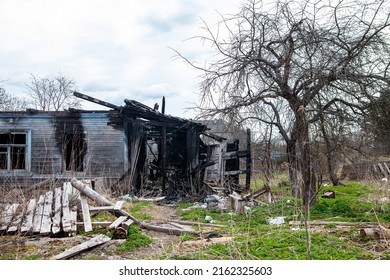 Photo of a burnt house . Charred beams of a wooden house. Burned down house.