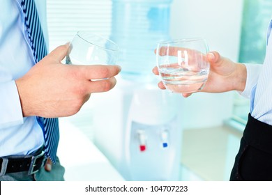 Photo of business partners hands holding glasses with water - Powered by Shutterstock