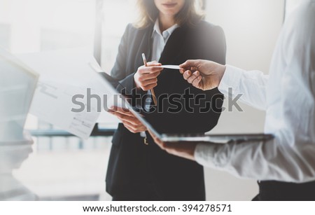 Photo business partners meeting. Team work. Business woman giving card colleague. Presentation new project modern office. Blurred background, film effect, horizontal