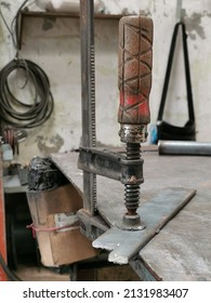 Photo Of C Clamp Holding Mild Steel Flat Bar On Metal Work Table.