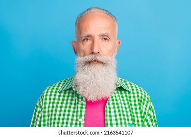 Photo Of Calm Content Aged Person No Emotions Face Look Camera Isolated On Blue Color Background