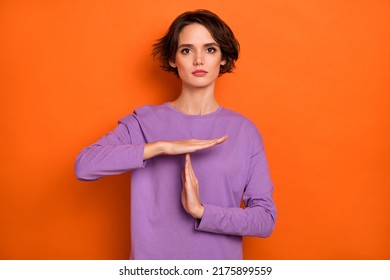 Photo Of Calm Focused Lady Hands Demonstrate Timeout Symbol Isolated On Orange Color Background