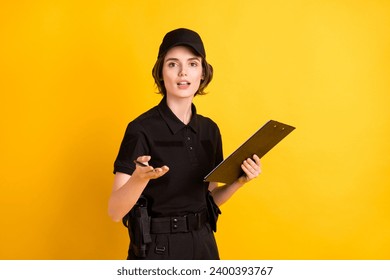 Photo of calm pretty person hold clipboard pen arm palm explain speak you isolated on yellow color background