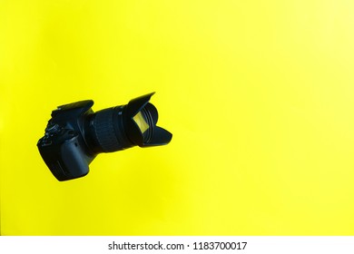 photo camera on a yellow background. Presentation of a new photo camera. Advertising. Fashion Style. Minimal Fun. Sale of photo equipment, Hobby - Shutterstock ID 1183700017