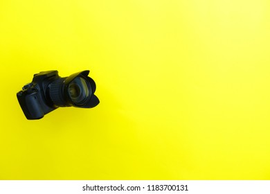 photo camera on a yellow background. Presentation of a new photo camera. Advertising. Fashion Style. Minimal Fun. Sale of photo equipment, Hobby - Shutterstock ID 1183700131