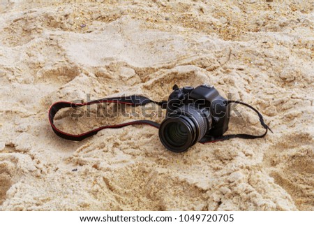 Photo camera in the sand