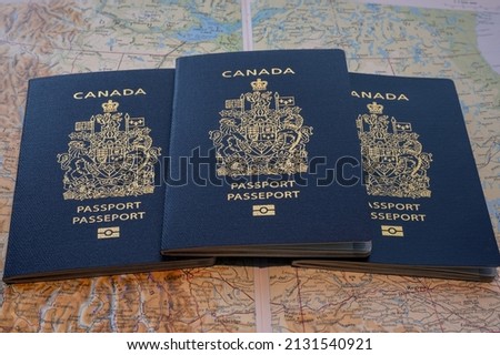 Photo of a Canadian passports against map of Canada.
