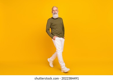 Photo Of Candid Retired Man Enjoy Stroll Wear Specs Green Shirt Trousers Footwear Isolated Yellow Color Background
