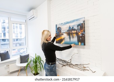 Photo Canvas Print. A Woman Holding A Photography With Gallery Wrap. Photo Printed On Glossy Synthetic Canvas And Stretched On Stretcher Bar