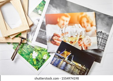 Photo Canvas Prints. Tool For Wrapping. Colorful Photographs, Pile Of Wooden Stretcher Bars And Canvas Pliers On Table. Photos Printed On Glossy Synthetic Canvas, Top View