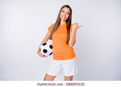 Photo of captain soccer team joyful lady direct thumb finger empty space euro cup 2020 league bets hold ball wear national team football uniform t-shirt shorts isolated white color background