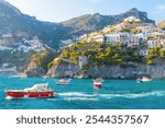 The photo captures a sunny view of Amalfi from a cruise ship, showcasing the town