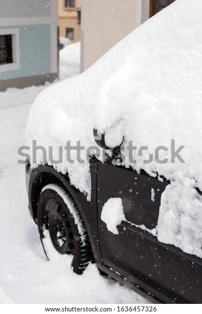 Photo of a car\
covered with snow, Heavy\
snowfall