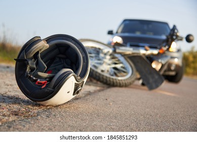 Photo of car, helmet and motorcycle on road, the concept of road accidents. - Shutterstock ID 1845851293