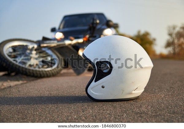 Photo of car, helmet and motorcycle on road,
the concept of road
accidents.