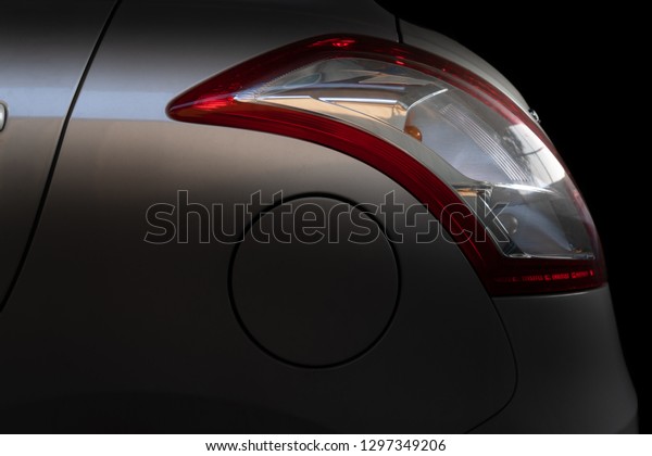 Photo of car tail\
lamp and fuel tank cover.