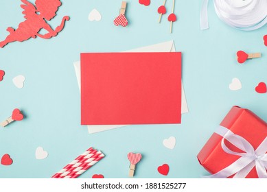Photo of card with place for writing message for lover. Top above close up view photo of red bright card and valentines day accessories on pastel table