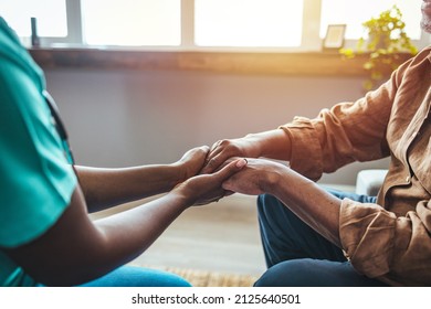 Photo Of Caring Nurse Or Doctor Holding An Elderly Hand With Care. Nurse Physiotherapist Doctor Holding Hands Of A Senior Or Elderly Old Man Patient With Love, Care, Helping, Encourage And Empathy 