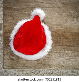 Photo Of Carpet Above The Floor. Free Space For Your Decoration. Red Santa Claus Hat.