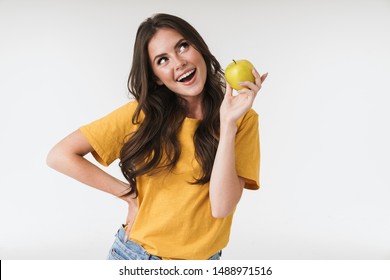 Photo Of Caucasian Woman 20s Wearing Casual Clothes Smiling And Holding Green Apple Isolated Over White Background