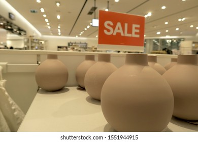 A Photo Of Ceramic Spherical Decorative Pots, With A Large Sale Sign And Store Interior In The Background