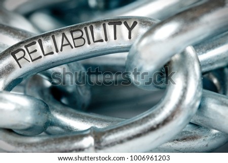 Photo of chains abstract closeup with RELIABILITY concept word imprinted on metal surface