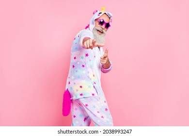 Photo of charismatic old man dance indicate finger you wear kigurumi pajama isolated pink color background