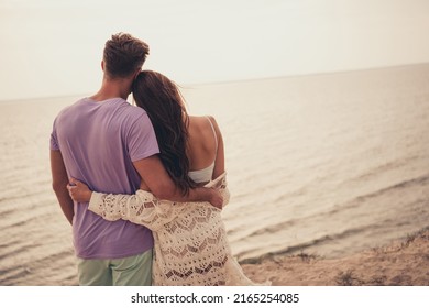 Photo of charming adorable young couple wear casual clothes hugging looking water outside countryside