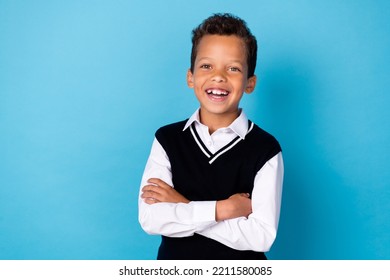 Photo Of Charming Cheerful Little Guy Dressed Black Vest Arms Folded Empty Space Isolated Blue Color Background