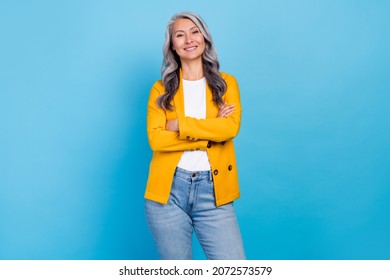 Photo Of Charming Confident Mature Woman Wear Yellow Jacket Smiling Arms Crossed Isolated Blue Color Background