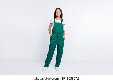 Photo of charming cool lady hands pockets look camera wear green overall isolated white color background - Shutterstock ID 1949659672