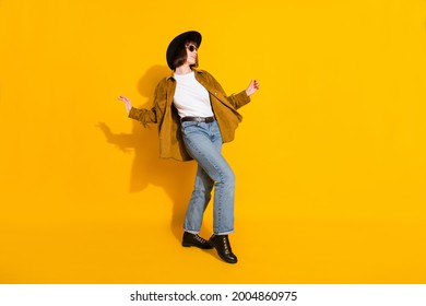 Photo of charming cute young lady wear cowgirl outfit dark glasses headwear dancing walking isolated yellow color background