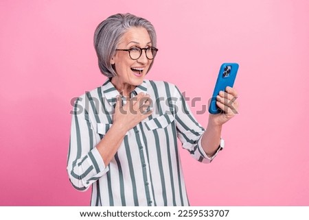 Photo of charming excited woman dressed smart casual reading sms modern gadget isolated pink color background