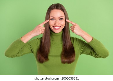 Photo Of Charming Happy Positive Lady Point Finger Eyes Good Mood Eyesight Isolated On Green Color Background